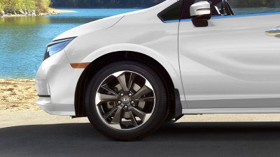 Closeup of tire on white Odyssey, lakeside.